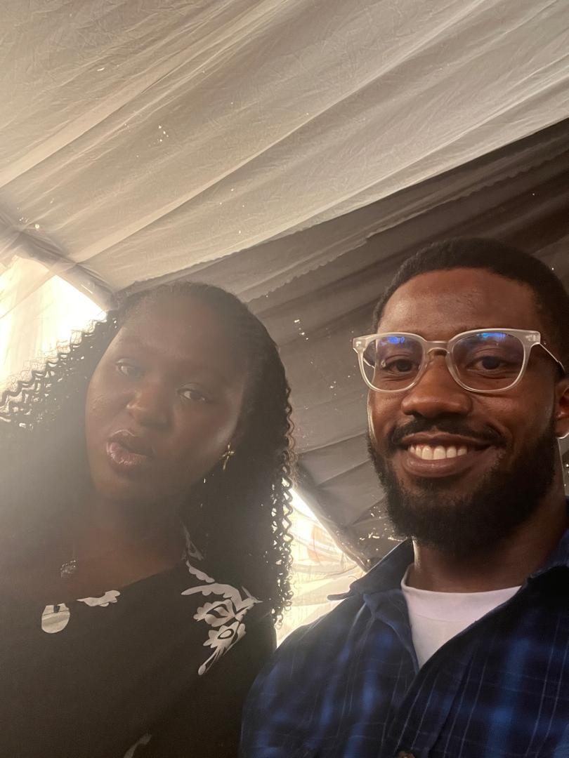 Nnenna and Chukwuma in a selfie under a tent canopy