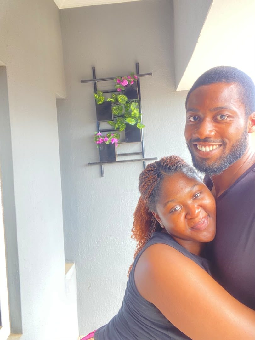 Nnenna and Chukwuma hugging on a balcony