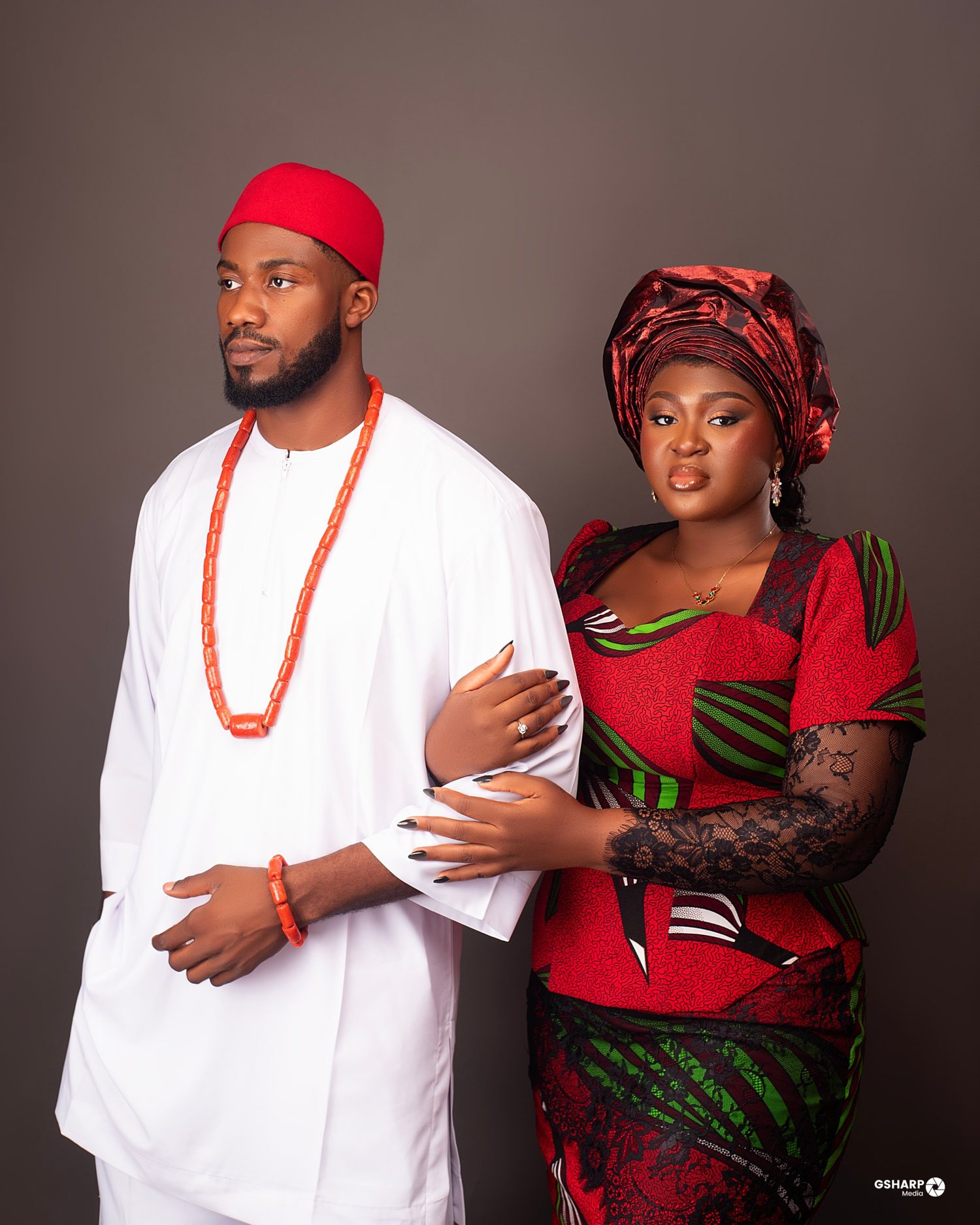 Nnenna holding Chukwuma’s arm, both in Igba Nkwu attire